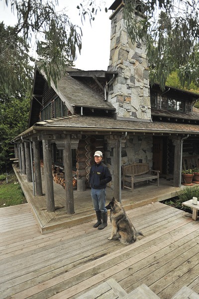 Architect Michael Yates has done extensive renovations on the log house he bought 23 years ago. His home was put on the city's Historic Property Register early this year.