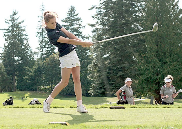 Bainbridge High School junior golfer Sara Colley tees off at the first hole in Monday’s match against Holy Names Academy.