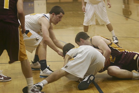 Chris Bell (left) and Adam Pool dive for a loose ball Tuesday.