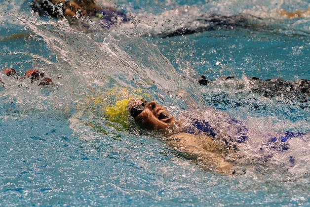 Ana Bucy races to the wall during the 100-yard backstroke preliminary race at the 3A Girls Washington State Swim & Dive Championships in Federal Way.