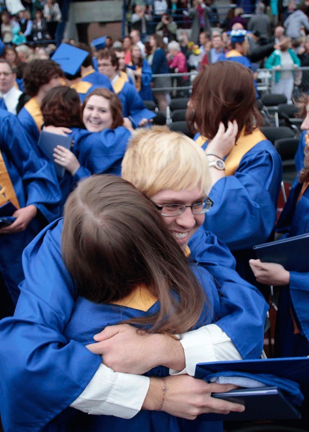 Members of Bainbridge High School's Class of 2014 share hugs at the close of commencement.