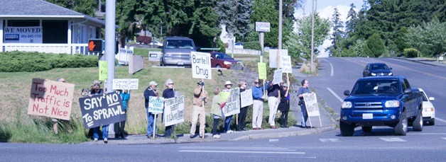 Islanders lined the corner of High School Road and Highway 305 to protest a proposed shopping center.