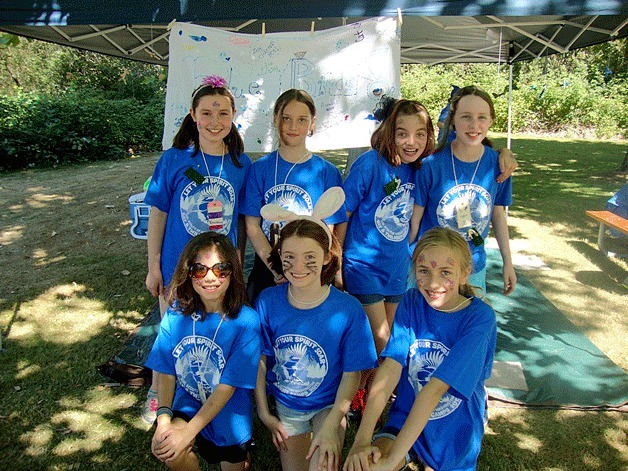 The fifth-grade campers called “Bluebirds” gather for a photo outside of their tent. In front is Bianca Daniels