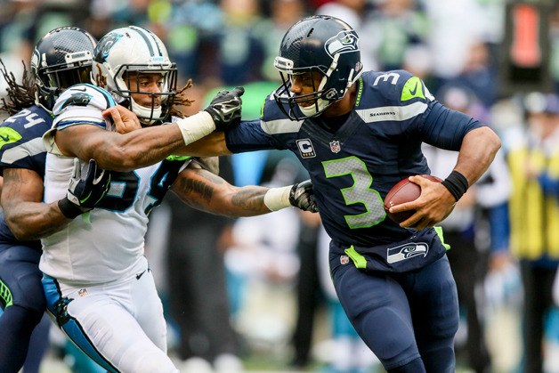 Seahawks' quarterback Russell Wilson tries to avoid the pressure by Panthers' linebacker Shaq Thompson with Seahawks running back Marshawn Lynch holding during the game at Century Link Field in Seattle on Oct.18