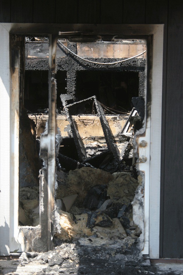 A look through the front door of The 122 shows the floor of the bar covered with blackened insulation and the collapsed roof of the building.