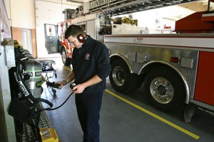 Firefighter Peter Redinger tests air packs at the Madison fire station Friday.