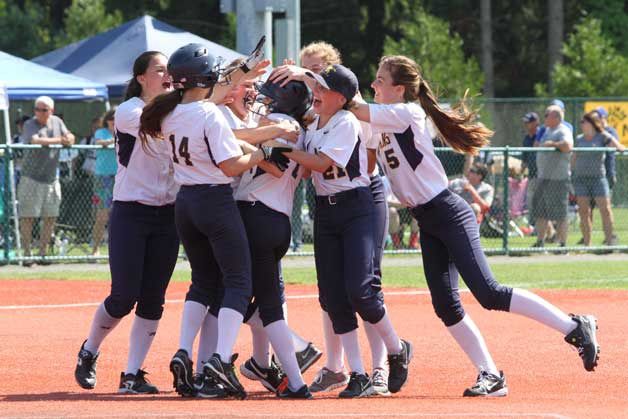 Spartan freshman Sara Colley is mobbed by her teammates after she won the second game at state for Bainbridge with a two-run