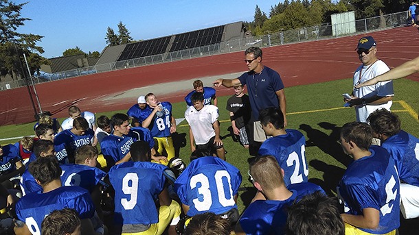 Spartan Head Coach Jeff Rouser talks with the Bainbridge High School varsity football team after a practice session last week. This will be Rouser’s first season at the helm of the island squad.