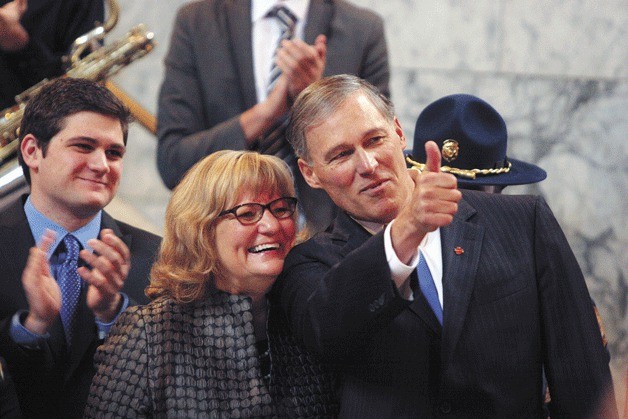 Jay Inslee stands with his wife Trudy in the capitol rotunda before his swearing-in Wednesday as governor of the state of Washington.