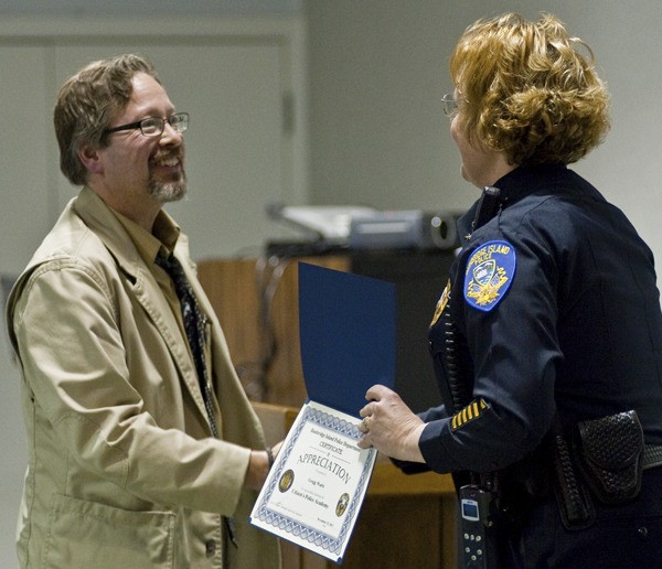 Police Cmdr. Sue Shutlz presents Gregg Watts with a certificate during Tuesday’s Citizens’ Academy graduation.