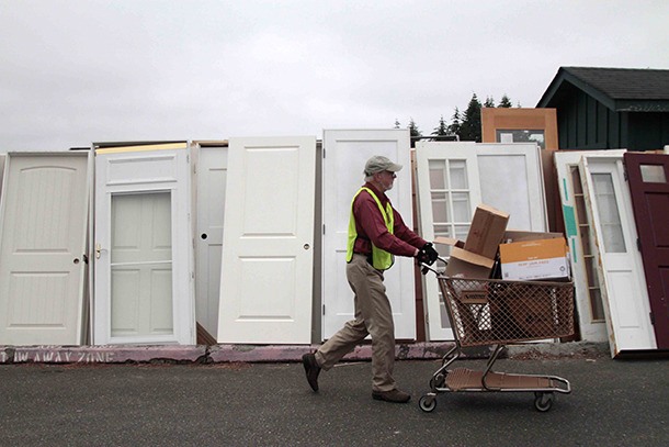 A volunteer walks past a row of doors while organizing the 2016 Bainbridge Island Rotary auction and rummage sale earlier this week.