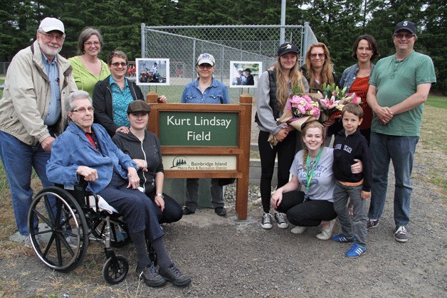 Members of Kurt Lindsay’s family gather around the new sign that shows the new name for Strawberry Hill Park’s Field 3.