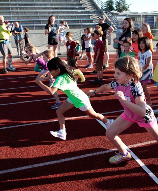 Young sprinters leave the starting line during the 60-yard dash event at  Monday’s Kiwanis All-Comers Track Meet at Bainbridge High School.