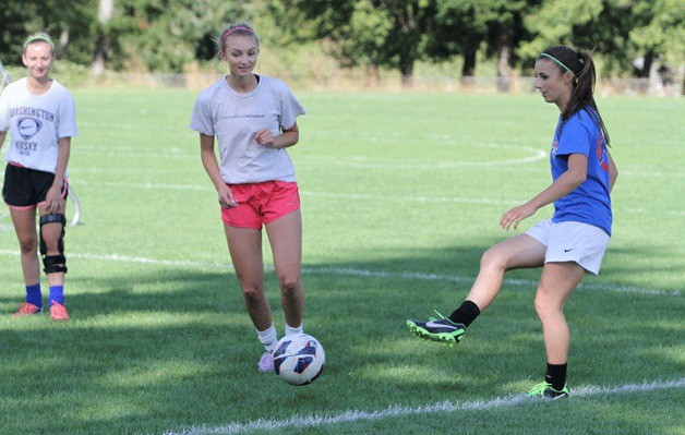 Spartan soccer team co-captain Riley Gregoire (far right) leads teammates in a keep-away drill at practice this week.