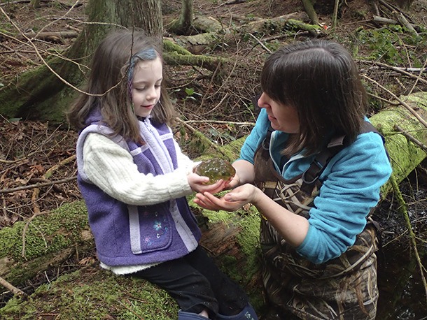 Amphibian expert Christina Doherty and a young citizen scientist examine a salamander egg mass in a local park.