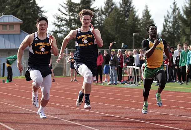Eric Jung and James Payne in the mens 100-meter dash at the first home track meet of the season.