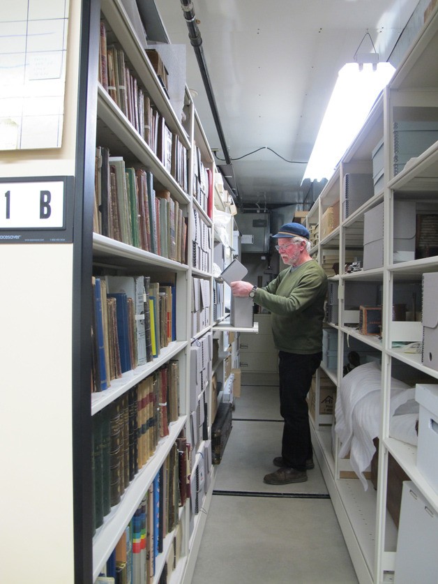 Curator Rick Chandler works in the collections storage area of the Bainbridge Island Historical Museum. The museum’s 3-D Thursdays begin in May