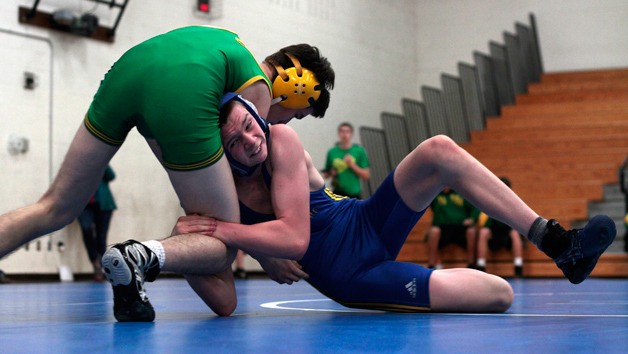 Greg Williams grapples with Bishop Blanchet's Jacob O'Donnel in the 132-pound match of the first round of the Bainbridge High varsity wrestling team's final home meet of the season last week.