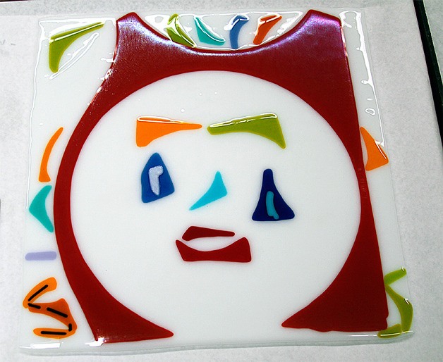 One example of the fused-glass self portraits made by artists of the Bainbridge Island Special Needs Foundation