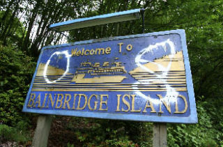 An ‘08 tag decorates the ‘Welcome to Bainbridge Island’ sign near the bridge.
