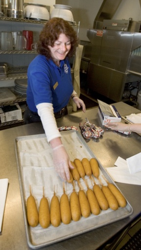 Nanette Bray loads trays of turkey and chicken corndogs