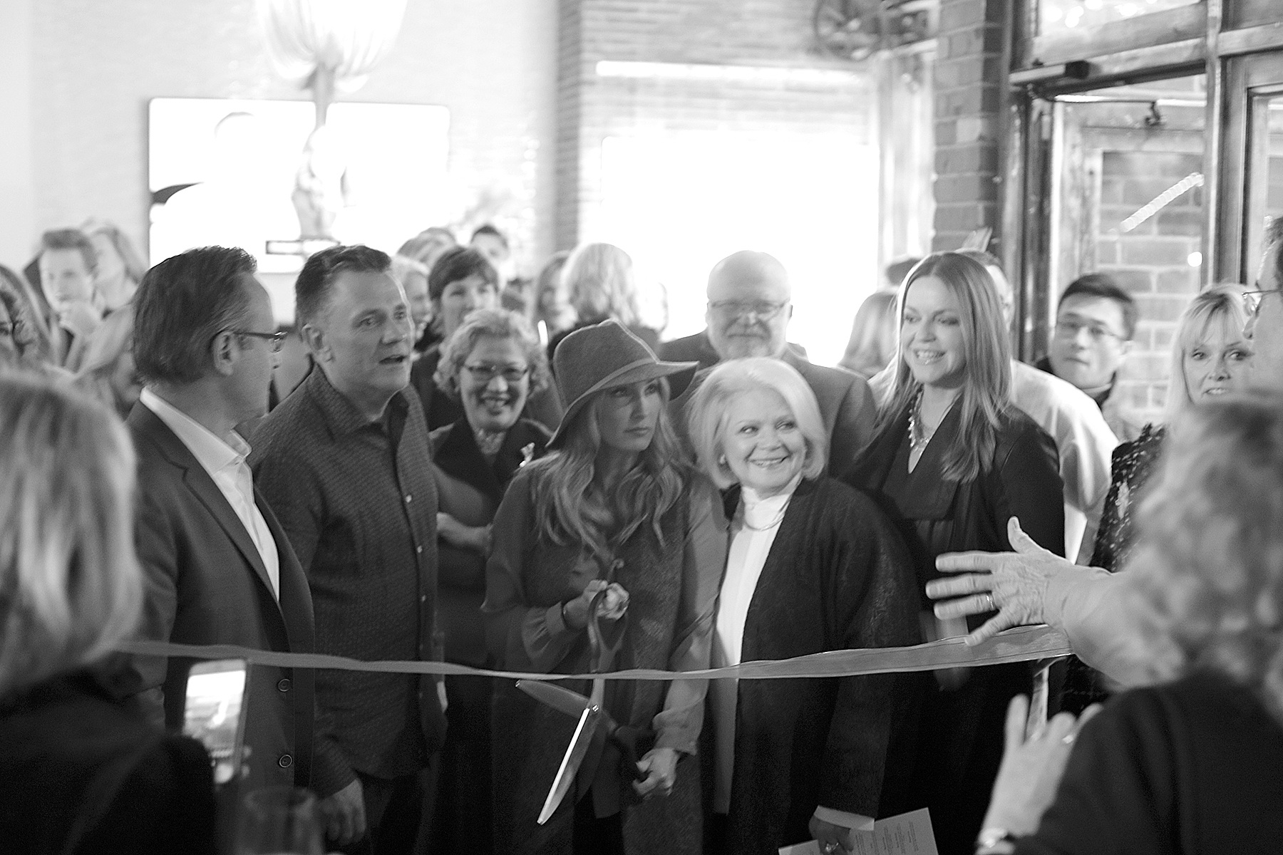Andrea Savage photo                                Realogics Sotheby’s vice president Stacy Jones prepares to cut the ribbon at the opening of the real estate firm’s new Island Living Gallery.