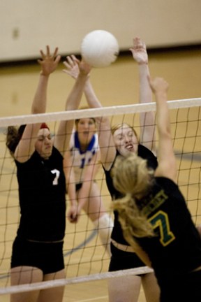Emily Donohue (left) and Dominique Atherley go up for the block on Bishop Blanchet’s Bridget Logan Thursday night.