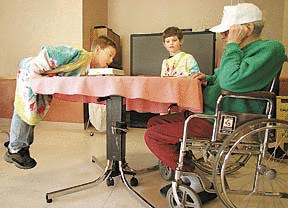 Keenan Monroe and Ben Marino play a heated game of checkers with an Island Health and Rehabilitation senior resident Thursday afternoon.