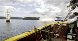 Lady Washington gunner Roscoe Washcher fires off one of the guns located on the Lady Washington at the Hawaiian Chieftain. The two ships were in the area as the Grays Harbor Historical Society brought them over for a public dockside tour.
