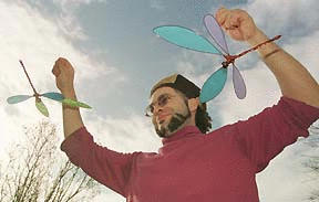 Artist Josh Gosick displays a pair of dragonflies