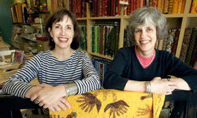 Deana Guthrie (left) and Maja Stone hope Island Textiles becomes a social center for island stitchers.