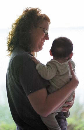 Fischer holds an infant foster child