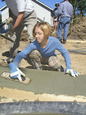 Lucie Gendreau smooths concrete at the Park View Drive construction site.
