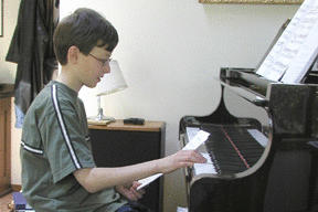 Ben Roth composes at the piano.