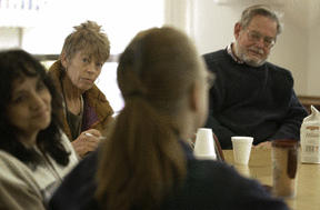 A movement therapist studying multiple sclerosis  and group facillitator Jim Vaughan (right) listen as a members of the support group talk about being diagnosed with MS.