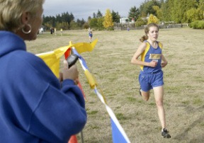 Spartan Hillary Pritchett crosses the finish line at the Battle Point Park during the girls cross country meet