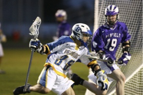 Bainbridge attacker Dylan Masi works for a goal against Garfield defender Paul Byrne Friday night. Masi had five goals and one assist in the Spartans’ 15-4 win over the Bulldogs in their first home game of the season. Bainbridge is currently 4-0 on the year.