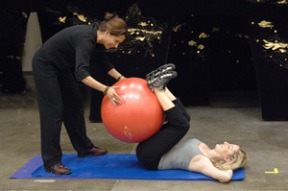 (L-R) Alexa Rosenthal of Island Fitness helps mezzo-soprano Jennifer Hines get fit for her role singing suspended in air.