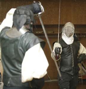 Instructor Nathan Barnett (white helmet) spars with student Dana Schenefeld.