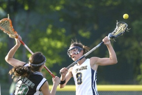 Mariah Walk (right) puts the ball in play on the face off during their playoff win against Forest Ridge on Tuesday.