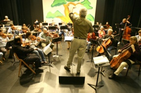 Zon Eastes (center) conducts the Bainbridge Symphony Orchestra in a rehearsal last week for “The Spirit of Russia.”
