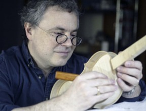 Thomas Mace uses a violin knife to carve a violin. It takes about five to six weeks to complete one.