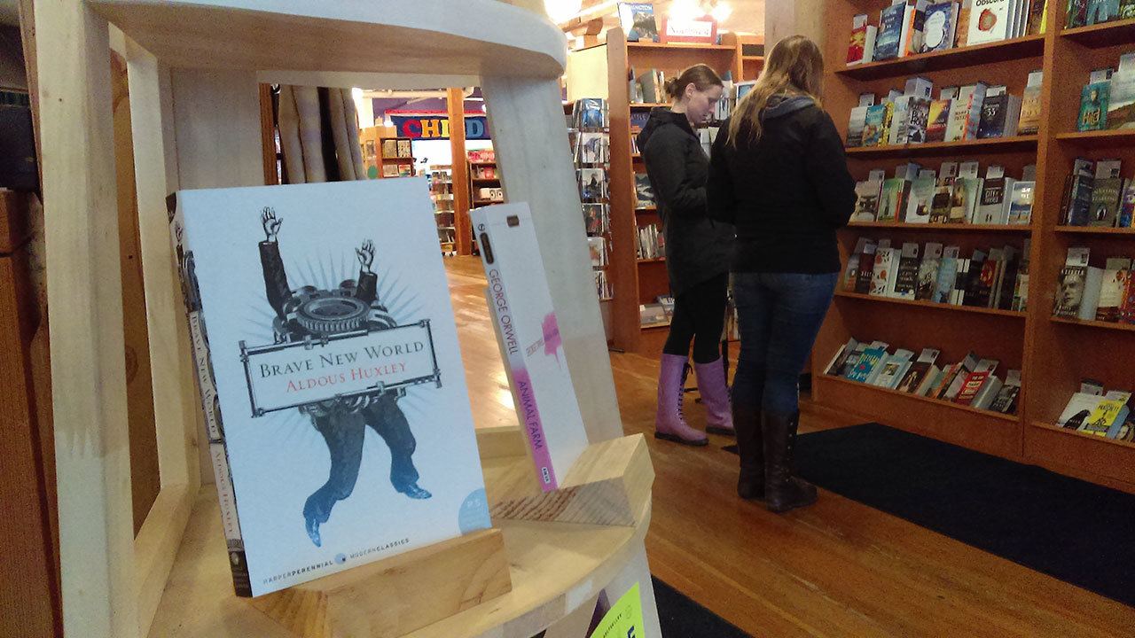 Luciano Marano | Bainbridge Island Review — Customers browse at Eagle Harbor Books in downtown Winslow in the shadow of several classic works of fiction that have been been receiving renewed attention across the country in the wake of recent political happenings.