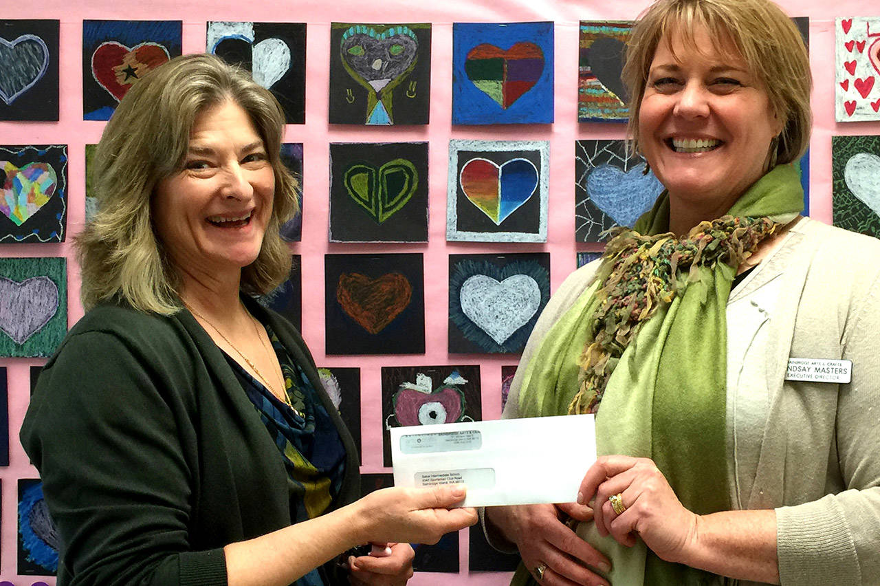 Photo courtesy of Bainbridge Arts & Crafts | Bainbridge Arts & Crafts Executive Director Lindsay Masters presents Sonoji Sakai Intermediate School art teacher Maggie Hitchcock with a check earlier this month as part of an annual donation effort by BAC to local elementary, middle, and high schools to supplement their art supply budgets and support visual art programming.
