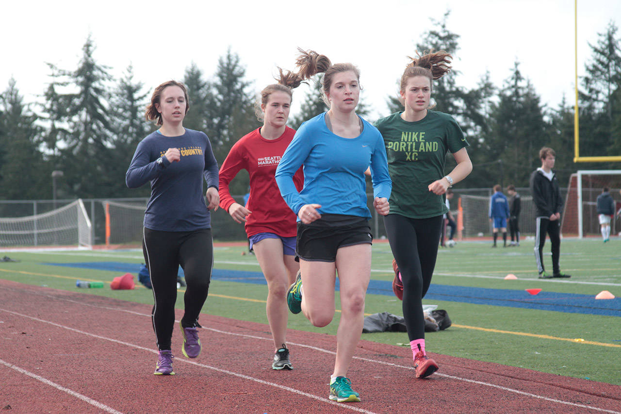 Luciano Marano | Bainbridge Island Review — Several members of the Bainbridge High School track and field team work through a practice session earlier this week.