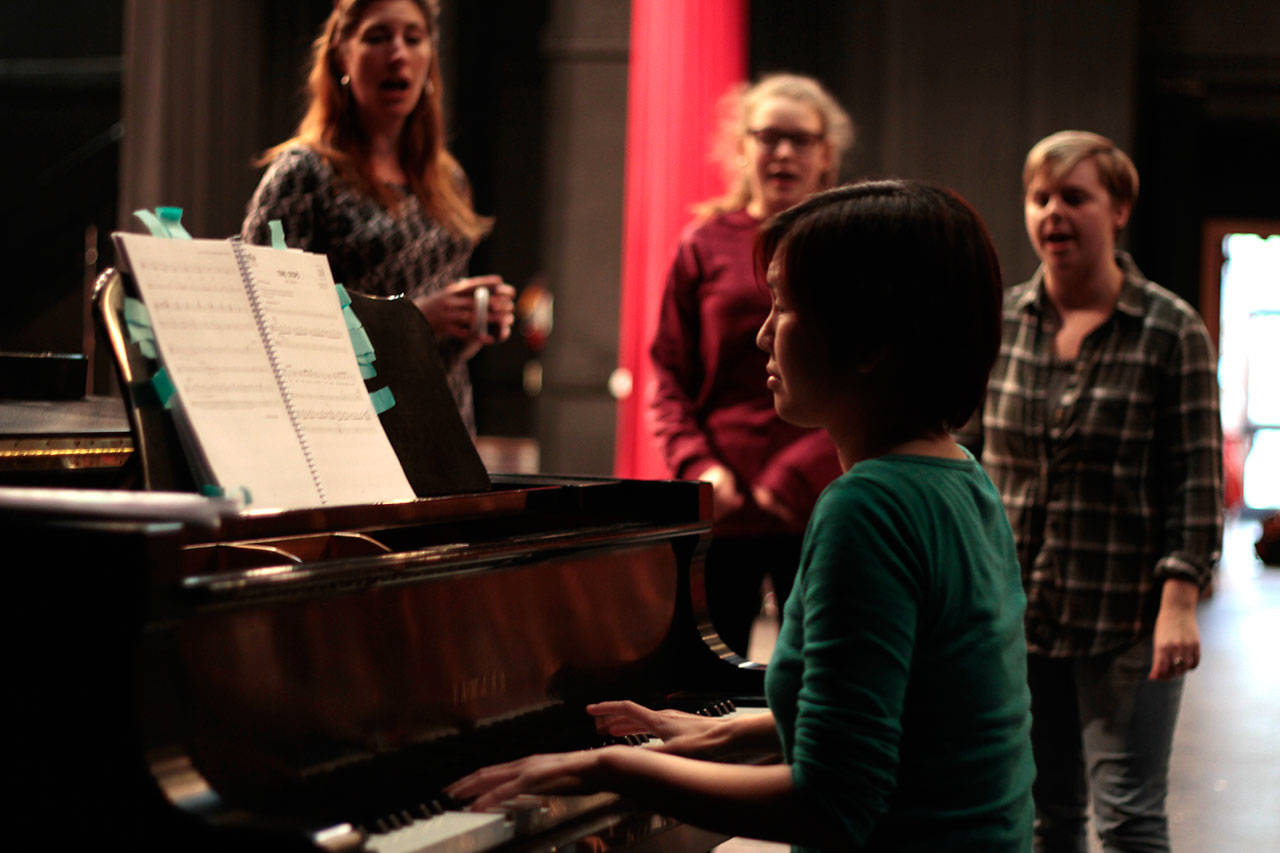 Luciano Marano | Bainbridge Island Review - Aimee Hong, in her Bainbridge Performing Arts debut as music director, leads a vocal warm up prior to a recent “Big Fish” practice session.