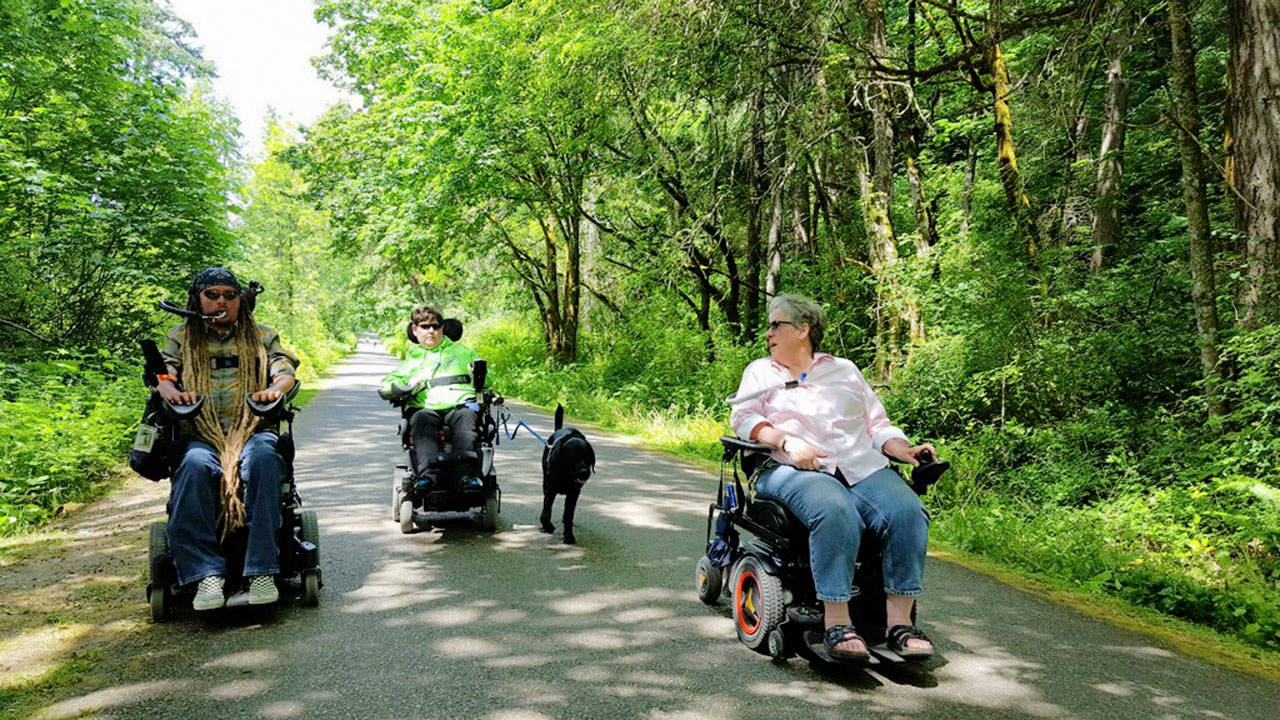 Photo courtesy of Marsha Cutting | Ian Mackay, Jenna Clark and Marsha Cutting at Fort Ward Park. Cutting and Mackay, of Port Angeles, will embark on a wheelchair hiking trip on several paved trails in the Paradise area of Mount Rainier to bring awareness to the need for more accessible trails on Monday, July 31.                                 Photo courtesy of Marsha Cutting | Ian Mackay, Jenna Clark and Marsha Cutting at Fort Ward Park. Cutting and Mackay, of Port Angeles, will embark on a wheelchair hiking trip on several paved trails in the Paradise area of Mount Rainier to bring awareness to the need for more accessible trails on Monday, July 31.                                 Photo courtesy of Marsha Cutting | Ian Mackay, Jenna Clark and Marsha Cutting at Fort Ward Park. Cutting and Mackay, of Port Angeles, will embark on a wheelchair hiking trip on several paved trails in the Paradise area of Mount Rainier to bring awareness to the need for more accessible trails on Monday, July 31.                                 Photo courtesy of Marsha Cutting | Ian Mackay, Jenna Clark and Marsha Cutting at Fort Ward Park. Cutting and Mackay, of Port Angeles, will embark on a wheelchair hiking trip on several paved trails in the Paradise area of Mount Rainier to bring awareness to the need for more accessible trails on Monday, July 31.