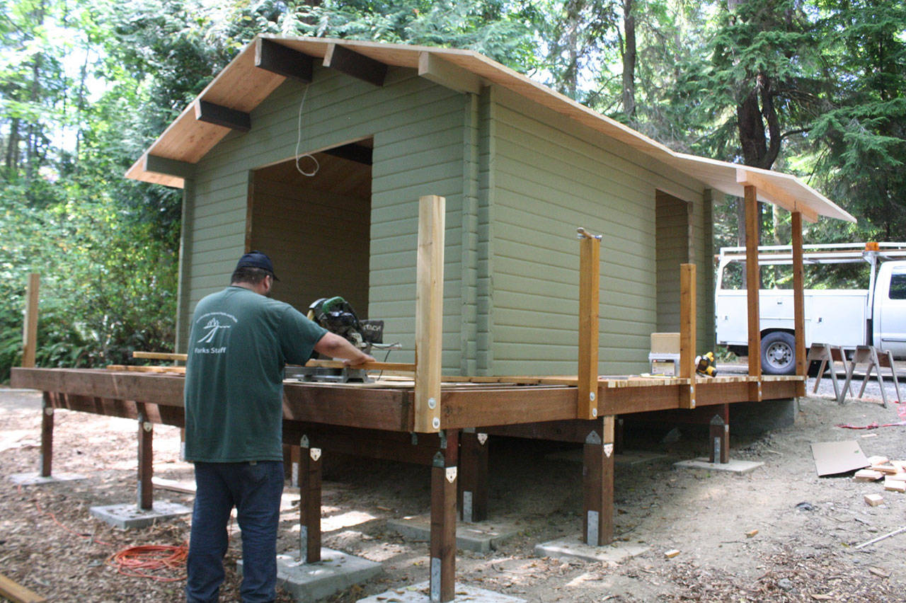 Nick Twietmeyer | The Bainbridge Island Review                                Casey Shortbull works to build the deck of one of the new cabins at Fay Bainbridge Park.