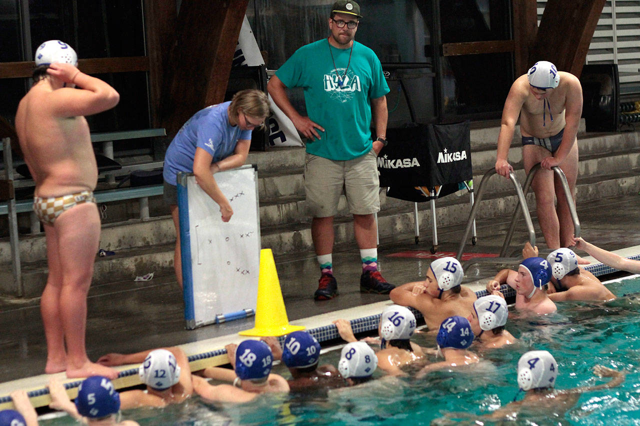 Luciano Marano | Bainbridge Island Review - Spartan boys varsity water polo team Head Coach Kristin Gellert talks strategy with the squad during a recent practice session.