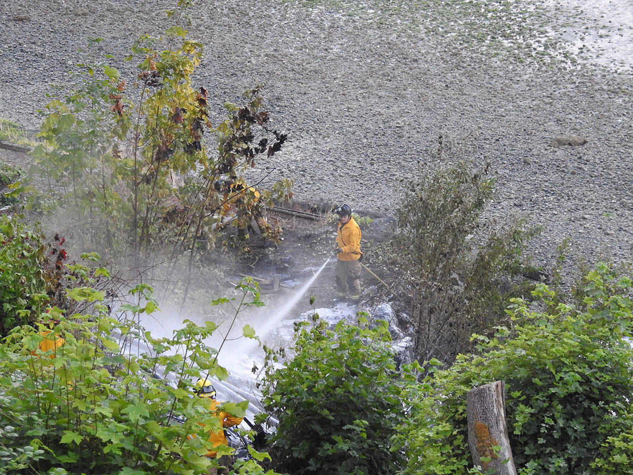 Photo courtesy of the Bainbridge Island Fire Department |                                 A Bainbridge firefighter works to extinguish a beach fire near Silven Avenue late last week. The Bainbridge Island Fire Department said the blaze was caused by a campfire that had not been extinguished the night before and had spread to the surrounding vegetation. With the fire danger estimated to be high to extreme, a Stage 2 burn ban was adopted on Bainbridge Tuesday.